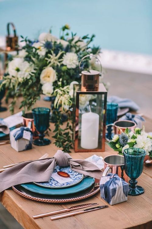 Destination weddings tend to have a small number of guests and a larger number of events. Indigo blue and copper tablescape, Mykonos Island, Greece.