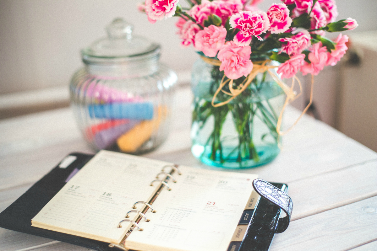 planner on desk with flowers